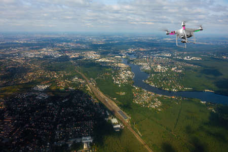 Quadrocopter flying over farmland at summerの写真素材