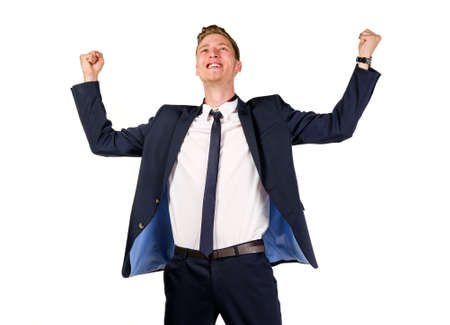 Happy young businessman raised fists isolated on whiteの写真素材