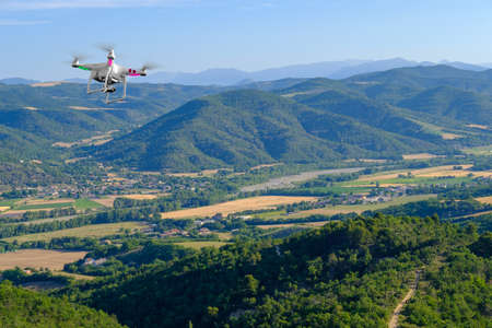 Quadcopter flies in countryside at Provence, Franceの写真素材