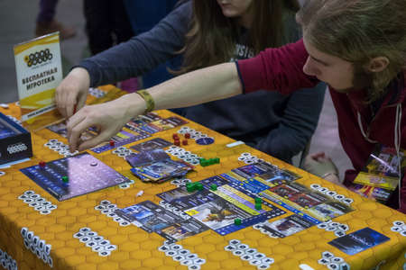 Moscow, Russia - November 19, 2016: People playing table game at the Gamefilmexpo festival dedicated...