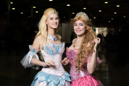 Two young woman cosplayer wearing beautiful dresses posing