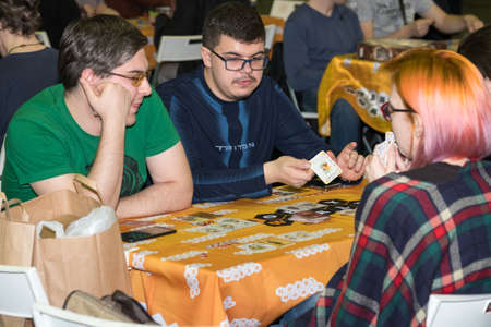 Moscow, Russia - November 20, 2016: People playing table game at the Gamefilmexpo festival dedicated to video games, TV series and comics, anime, manga, cosplay.のeditorial素材