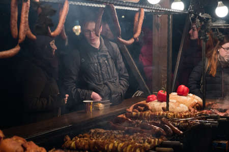 Krakow, Poland - December 19, 2016: People visit Christmas market at main square in old city and buy various traditional foodのeditorial素材