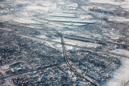 Road junction aerial view at winterの写真素材