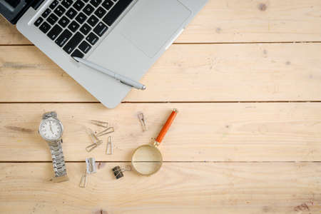 Wooden desk with various gadgets and accessories, top viewの写真素材
