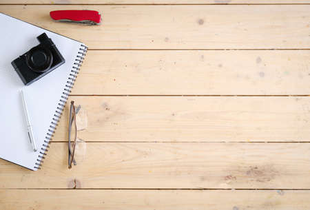 Wooden desk with various gadgets and accessories, top view