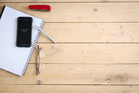 Wooden desk with various gadgets and accessories, top viewの写真素材