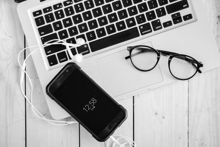 Wooden desk with various gadgets and accessories, top viewの写真素材