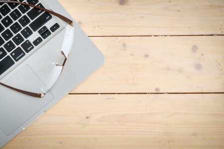 Wooden desk with various gadgets and accessories, top viewの写真素材