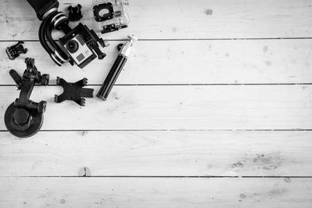 Action camera on the wooden table with a stabilizer and other accessoriesの写真素材