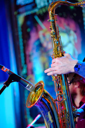 Musician plays the saxophone on the stageの写真素材