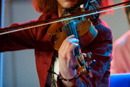 Young woman playing the violin close up