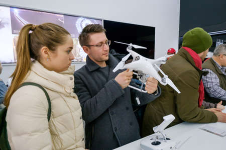Moscow, Russia - April 1, 2017: Customers watch quadrocopters at the opening of DJI Authorized Storeのeditorial素材
