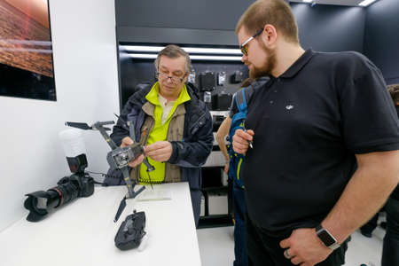 Moscow, Russia - April 1, 2017: Customers watch quadrocopters at the opening of DJI Authorized Storeのeditorial素材
