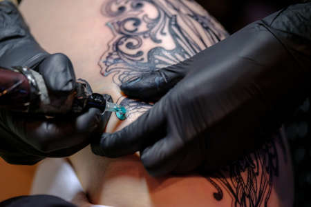 Moscow, Russia - April 2, 2017: Artist making a tattoo for Tattoofest visitorのeditorial素材