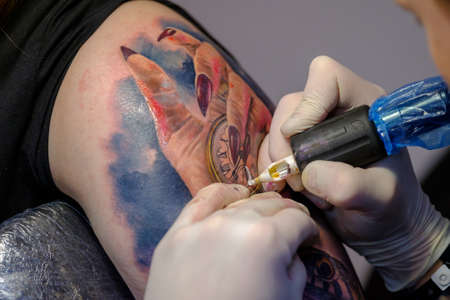 Moscow, Russia - April 2, 2017: Artist making a tattoo for Tattoofest visitorのeditorial素材