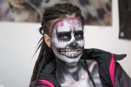 Moscow, Russia - April 2, 2017: Make-up artist paints the skull on the girls faceのeditorial素材