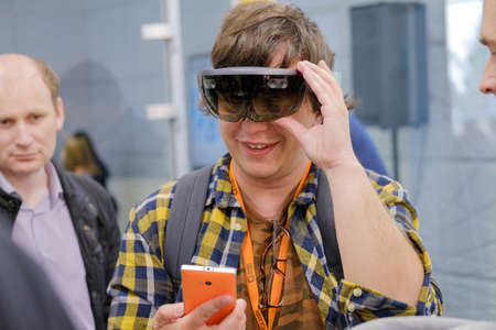 Moscow, Russia - June 8, 2017: Young man testing hololens VR glasses at VR conferenceのeditorial素材