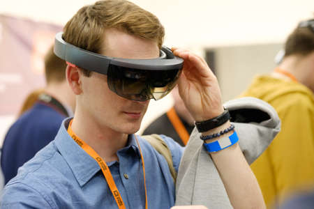 Moscow, Russia - June 8, 2017: Young man testing hololens VR glasses at VR conference