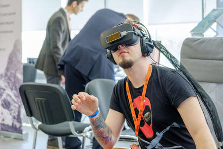 Moscow, Russia - June 8, 2017: VR conference visitor tests virtual reality helmetのeditorial素材