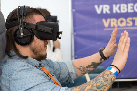 Moscow, Russia - June 8, 2017: VR conference visitor tests virtual reality helmetのeditorial素材