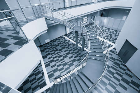 Modern office hall with stairs toned in blue