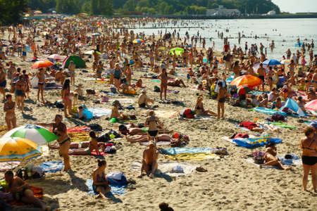 Pionerskij ,Russia - July 30, 2017: People relax and sunbathing at Baltic Sea shore at sunny summer dayのeditorial素材