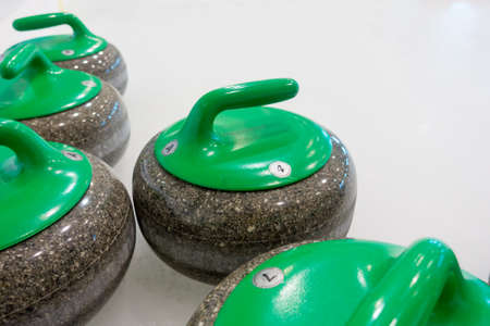 Curling stones equipment on the iceの写真素材