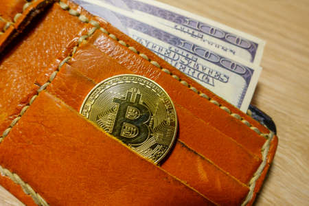 Golden bitcoin coin in the leather wallet top vievの写真素材