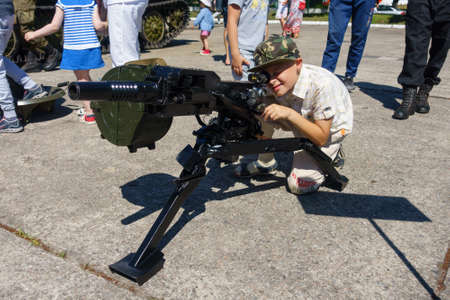 Baltijsk, Russia - July 30, 2017: Unidentified children age 5-10 years try real weapons during the parade of the Russian Navyのeditorial素材
