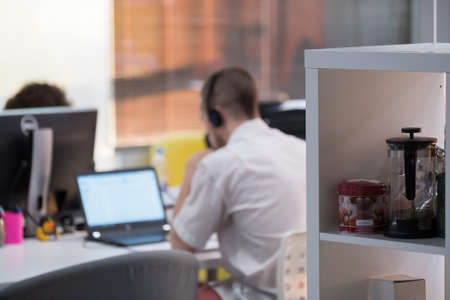 Man works at laptop, back viewの写真素材