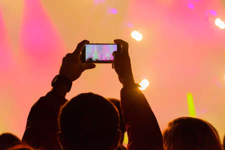 Concert visitor shoots video on a smartphone