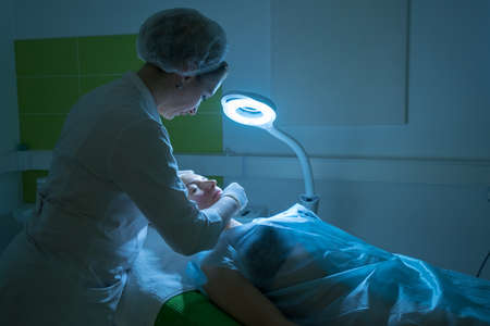 Young woman during the procedure in the clinic of aesthetic cosmetology