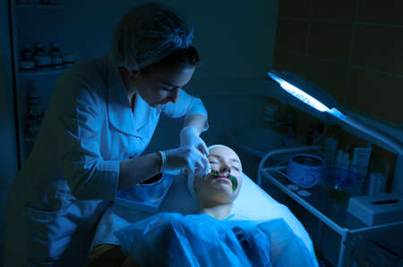 Young woman during the procedure in the clinic of aesthetic cosmetology