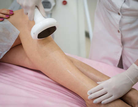 Young woman during the procedure in the clinic of aesthetic cosmetologyの写真素材