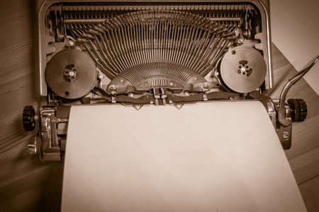 Typewriter ready for use with blank paper installed macro black and white background. Top view. Sepia toneの写真素材
