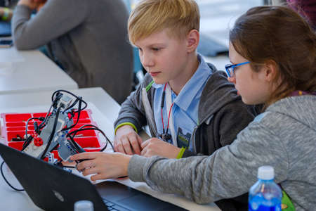 Moscow, Russia - April 24, 2018: Children learn how to program a robot at Skolkovo Robotics Forum