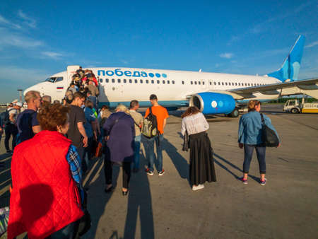 Moscow, Russia - April 19, 2018: Passengers boarding on the aircraft of low cost airline company Pobedaのeditorial素材