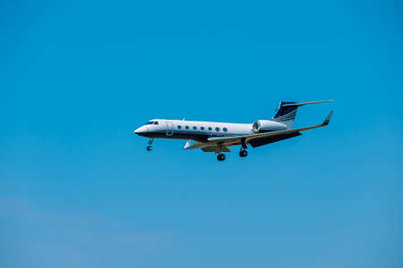 Private small air jet flying in the blue sky