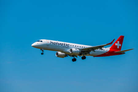Zurich, Switzerland - July 19, 2018: Helvetic Swiss airlines airplane preparing for landing at day time in international airportのeditorial素材