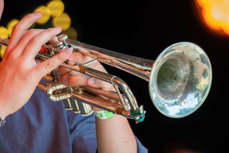 Musician playing trumpet at live concert on the stageの写真素材