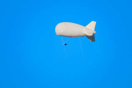 airship flies in the blue sky, add your advertisementの写真素材