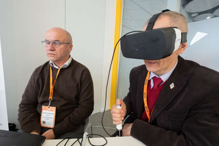 Moscow, Russia - April 3, 2018: Conference visitor tests virtual reality helmetのeditorial素材