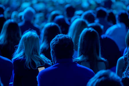 Audience listens to the lecturer at the business conference, back viewの写真素材