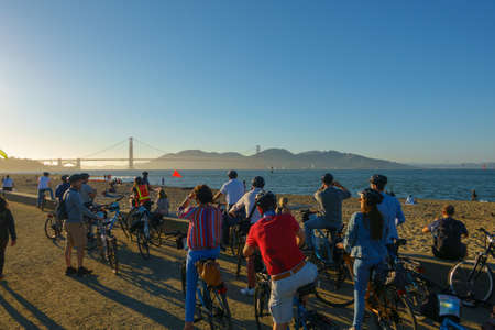 San Francisco, USA - September 10, 2018: Tourists watching Bridge Golden Gate at sunset time during bicycle group sightseeing tourのeditorial素材