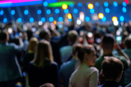 Audience listens to the lecturer at the business conference, back view, blue tones, defocusedの写真素材