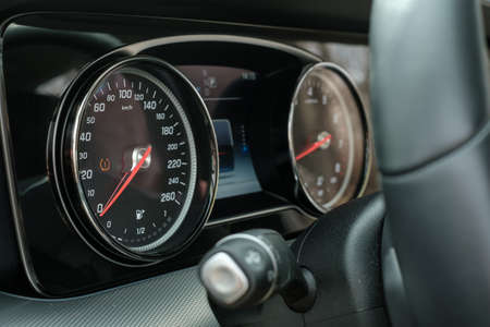 Speedometer at dashboard of luxury car close up