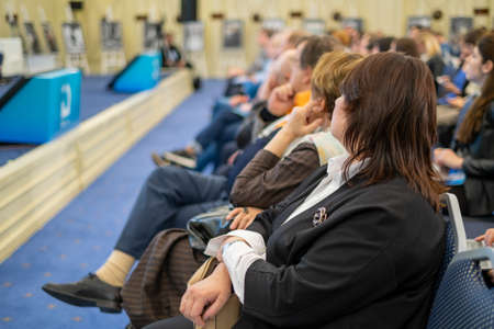 Audience listens to the lecturer at the business conference, back viewの写真素材