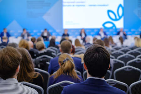 Audience listens to the lecturer at the business conference, back viewの写真素材
