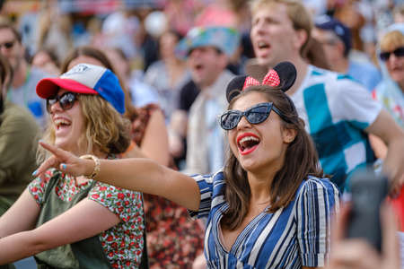 Moscow - June 22, 2019: Girls emotionally react to musician performance at open air music festival